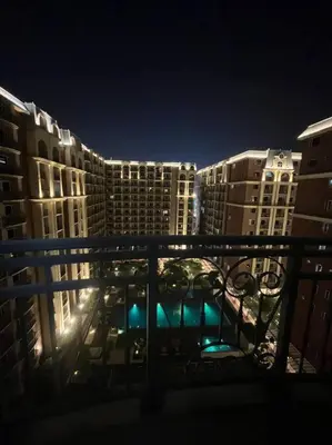 a view of a city at night with tall buildings at Cozy 1-BR Retreat Near MOA Pool view in Manila