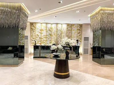 a lobby with a table with flowers on it at 1BR Condotel with Balcony at FAME Residences #FM56 in Manila