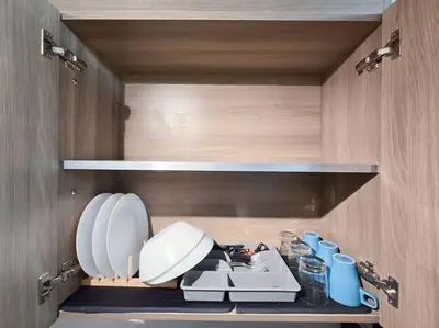a kitchen with a sink and cups on a shelf at 1BR Condotel with Balcony at FAME Residences #FM57 in Manila