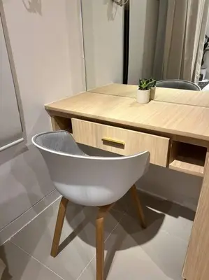a white chair sitting in front of a wooden desk at Chic & Cozy Apartment Near BGC with Home Theater Setup in Manila