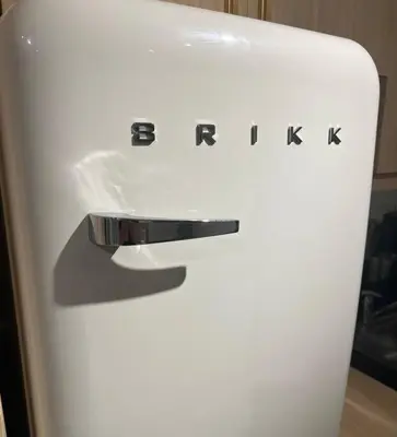 a white refrigerator with the words bmw on it at Chic & Cozy Apartment Near BGC with Home Theater Setup in Manila