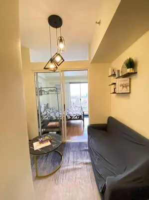 a living room with a couch and a table at Easy Escape 1bedroom unit Satori Pasig in Manila