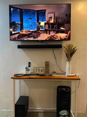 a desk with a television on a wall with a bedroom at A private house with swimming pool- Unit1 in Kawit