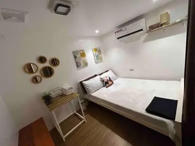 a small room with a bed and a small table at A private house with swimming pool- Unit1 in Kawit