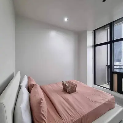 a bedroom with a bed with a basket on it at Cozy Two Bedroom Flat in The Gramercy Residences in Manila