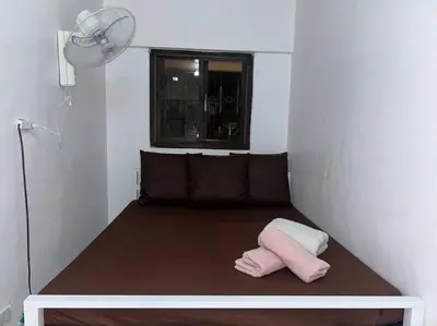 a room with a bed with a pillow on it at ACL Staycation Home in Imus & Kawit with portable pool unit 2 in Kawit