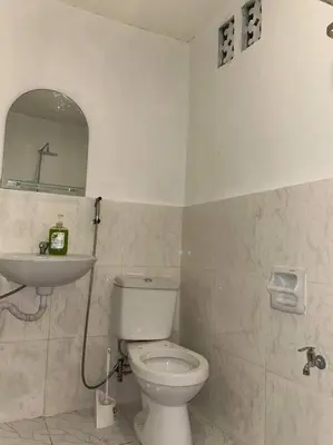 a bathroom with a toilet and a sink at ACL Staycation Home in Imus & Kawit with portable pool unit 2 in Kawit