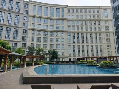 a large building with a large pool in front of it at The Nest C5-7F EightyOne Newport Boulevard Condominium, Pasay City in Manila