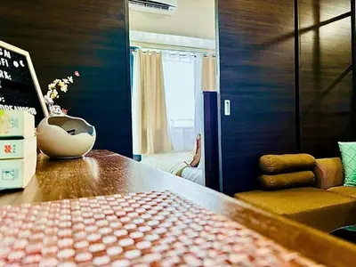 a room with a table and a chair and a window at Ikigai's Alpha Makati City View Condo with Balcony Perfect for Relaxation in Manila