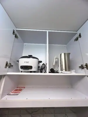 a kitchen shelf with a toaster and a appliance at Hadisha Suite Spring Residence in Manila