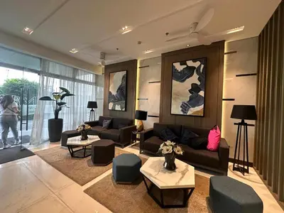 a living room with a couch and chairs and a table at The Finest Charm Residences by Ashti in Manila