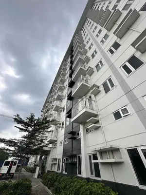 a large white building with balconies on the side of it at The Finest Charm Residences by Ashti in Manila