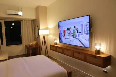 a bedroom with a large flat screen tv on the wall at Air Residence- Makati in Manila