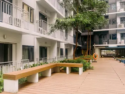 a park bench in front of a building at Oranje Suite Near Naia Terminal in Manila