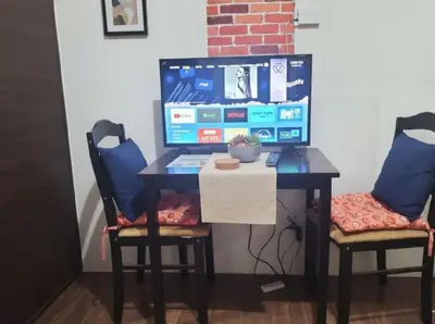 a desk with a computer on it with two chairs at Central Makati CBD in Manila