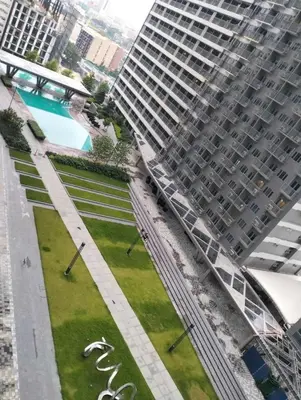 an aerial view of a park in front of a large building at Central Makati CBD in Manila