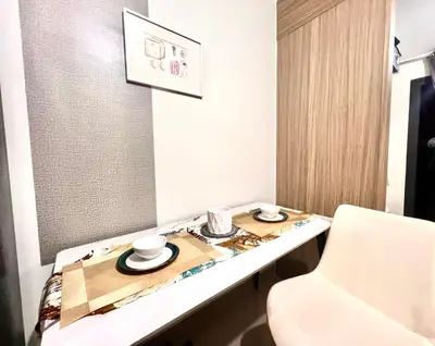 a room with a table with two cups on it at Cozy Home in Mall of Asia - Aseana Pasay in Manila