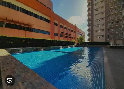 a large swimming pool in front of a building at Laureano Di Trevi Tower in Manila