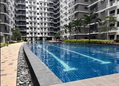 a large swimming pool in the middle of a building at Urban Luxe Stay at Shore 3 in Manila
