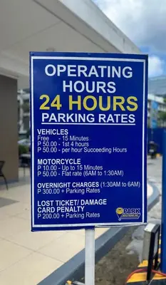 a sign in front of a parking garage at Cozy Hearth Loft at Shore 3 in Manila