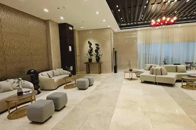 a lobby with couches and tables in a building at 1BR self-contained CONDO in Makati with amenities! in Manila