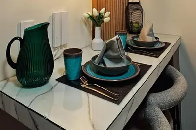 a table with plates and hats on top of it at 1BR self-contained CONDO in Makati with amenities! in Manila