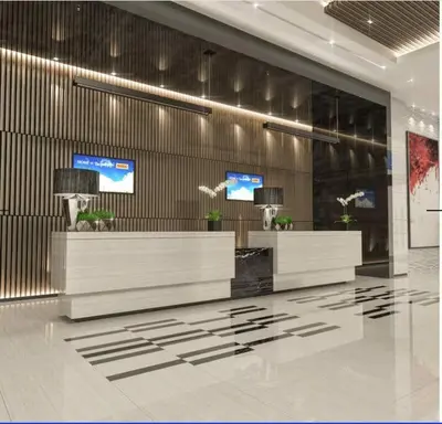 a lobby with two reception desks in a building at 1BR self-contained CONDO in Makati with amenities! in Manila
