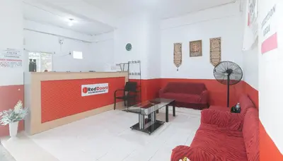 a living room with a couch and a table at RedDoorz at Najar Residences near NAIA Terminal in Manila