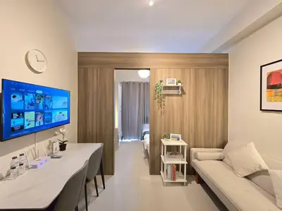 a living room with a couch and a table at 1BR Condotel with Balcony at FAME Residences #FM59 in Manila