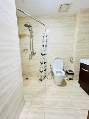 a bathroom with a shower and a toilet in it at Budget Twin-1Bedroom at Ace Suites in Manila