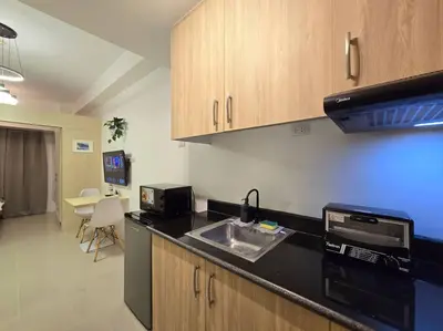 a kitchen with a sink and a counter top at 1BR Condotel with Balcony at SM Light Residences #LT08 in Manila
