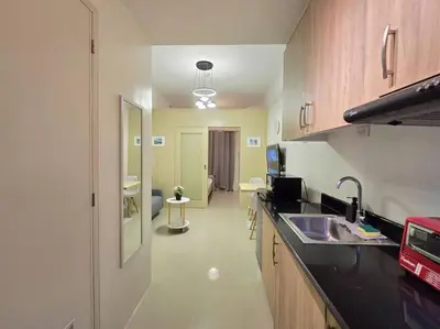 a kitchen with a sink and a counter top at 1BR Condotel with Balcony at SM Light Residences #LT09 in Manila