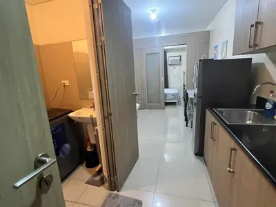 a small kitchen with a sink and a refrigerator at Shore Family Suite 2 Beds WiFi TV Netflix Near MOA 9120 in Manila