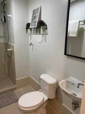 a bathroom with a toilet and a sink at SMDC Park Residences near SM City Sta Rosa unit 1 in Ibaba