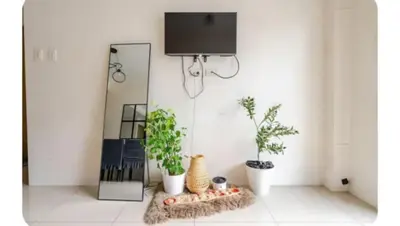a room with two plants and a tv on a wall at Sosyal Staycation , Pasay City Shore Residences Tower D Sunrise Drive Mall of Asia Complex Pasay City Philippines SMDC SHORE 1 RESIDENCES Pasay City in Manila
