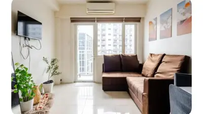a living room with a couch and a tv at Sosyal Staycation , Pasay City Shore Residences Tower D Sunrise Drive Mall of Asia Complex Pasay City Philippines SMDC SHORE 1 RESIDENCES Pasay City in Manila