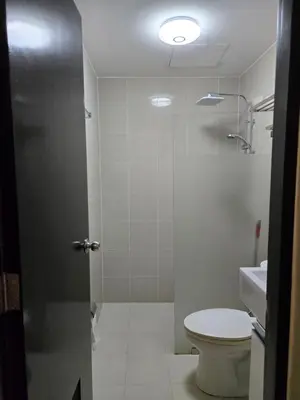 a bathroom with a toilet and a sink at Cozy 2BR 2BA 2 Balconies Manhattan Heights Cubao in Manila