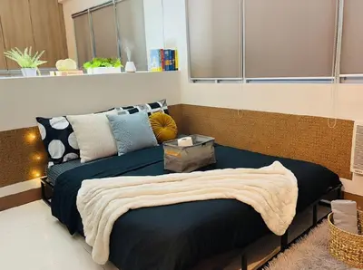 a bedroom with a bed and a couch at Heart of BGC in Manila