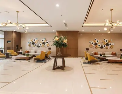 a lobby with couches and a table with flowers at The Room of Requirement in Manila