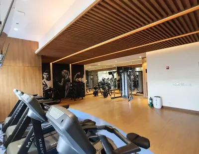 a gym with treadmills and cardio equipment in a building at The Room of Requirement in Manila