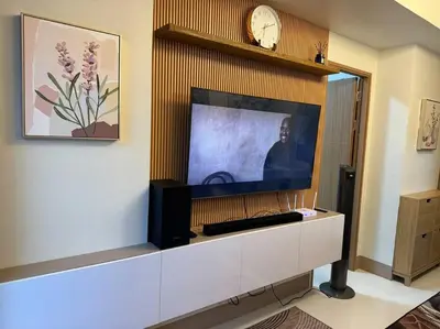 a large flat screen tv sitting on top of a cabinet at 2BR Unit in SMDC Shore 3 with pool access in Manila