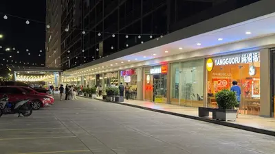 a shopping mall at night with people walking around at 2BR Unit in SMDC Shore 3 with pool access in Manila