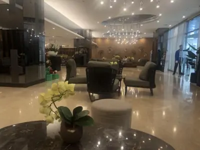 a lobby with chairs and a table and a chandelier at TresMaria'Staycation in Manila