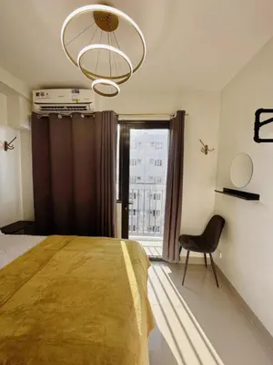 a bedroom with a bed and a chair and a window at 19106 Condotel at Shore 2 MOA wNetflix in Manila