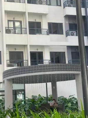 a building with a walkway in front of it at SM HOME Spring Residences Staycation and Condotel in Manila