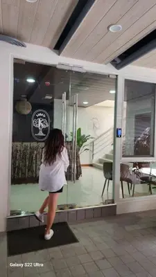 a woman walking in front of a glass window at Serene Summer close proximity to Araneta Centre in Manila