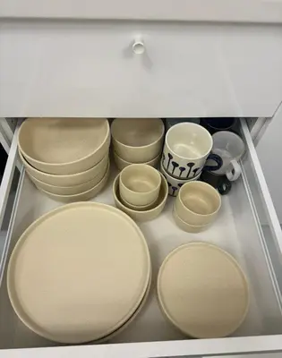 a group of plates and bowls in a drawer at Chic and Cozy Minimalist Condo with Pool in Makati City in Manila