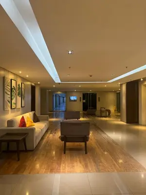 a living room with a couch and a table at Chic and Cozy Minimalist Condo with Pool in Makati City in Manila