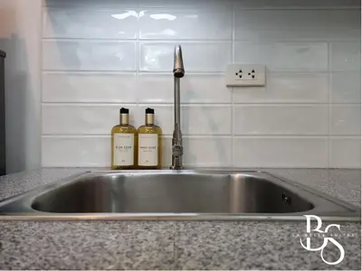 two bottles of wine sitting on a kitchen sink at The Beacon Makati New Renovated Studio Ayala Greenbelt CBD Makati PH in Manila