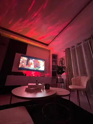 a living room with red lights on the ceiling at LUCKY 7 Suites in Manila